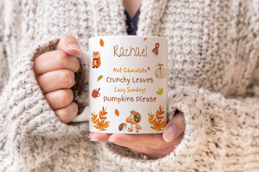 A personalised mug with autumnal design and decorations
