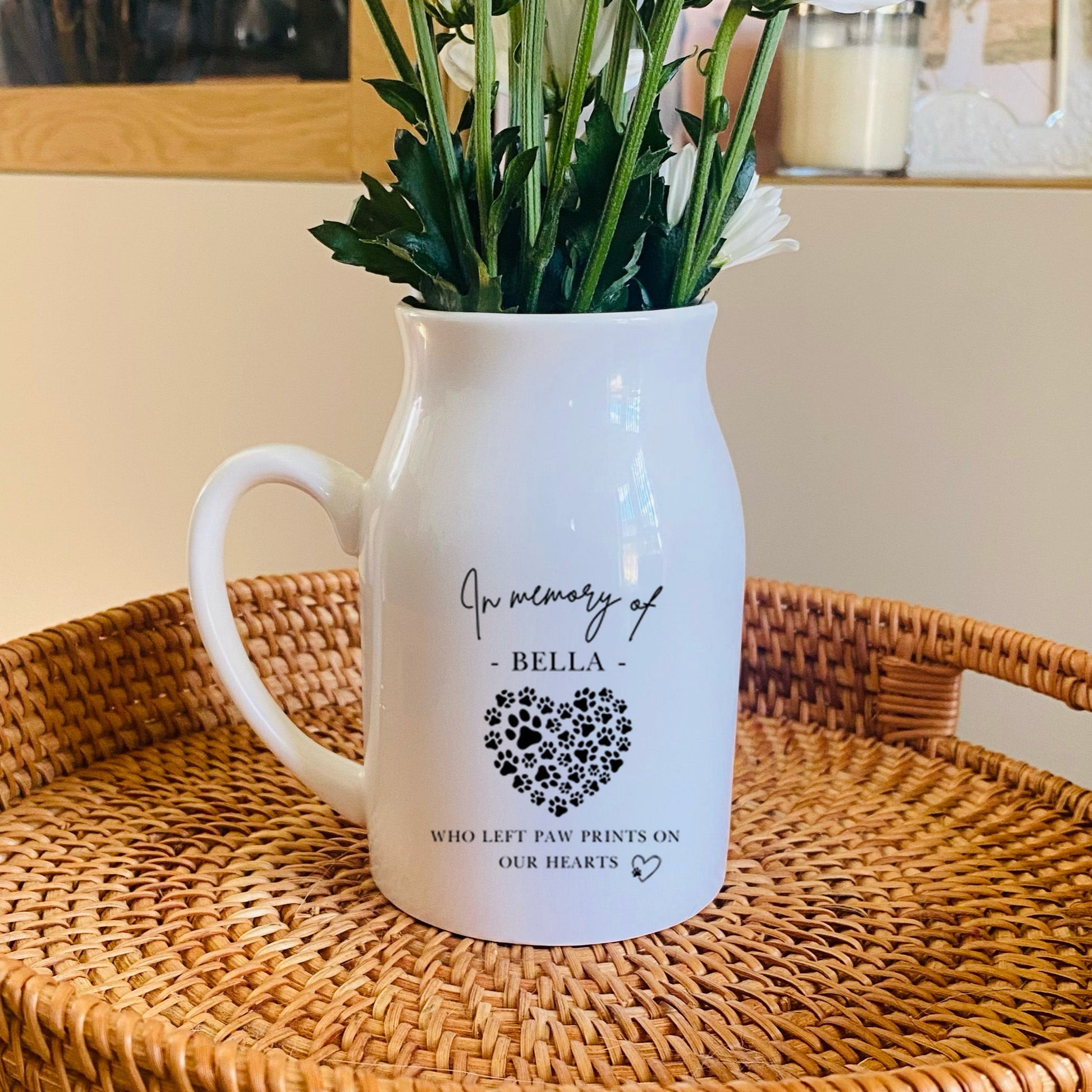 White Pet Memorial Vase pitcher with floral arrangement on a woven tray in a home setting