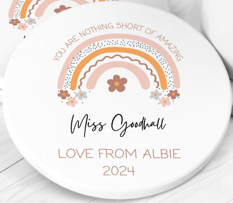 Custom round white coaster featuring a pastel rainbow and floral motif with the message “You are nothing short of amazing.” Personalised with “Miss Goodhall – Love from Albie 2024.” A thoughtful thank you gift for teachers or teaching assistants.