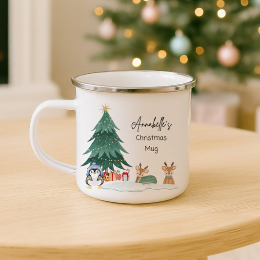 Personalised Christmas mug with festive design on a table in front of a decorated Christmas tree.
