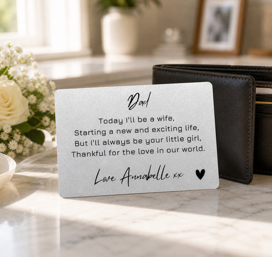 Card for a father from his daughter on a marble surface with flowers and a wallet in the background