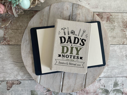 Notebook with 'Dad's DIY Notes' on a wooden surface