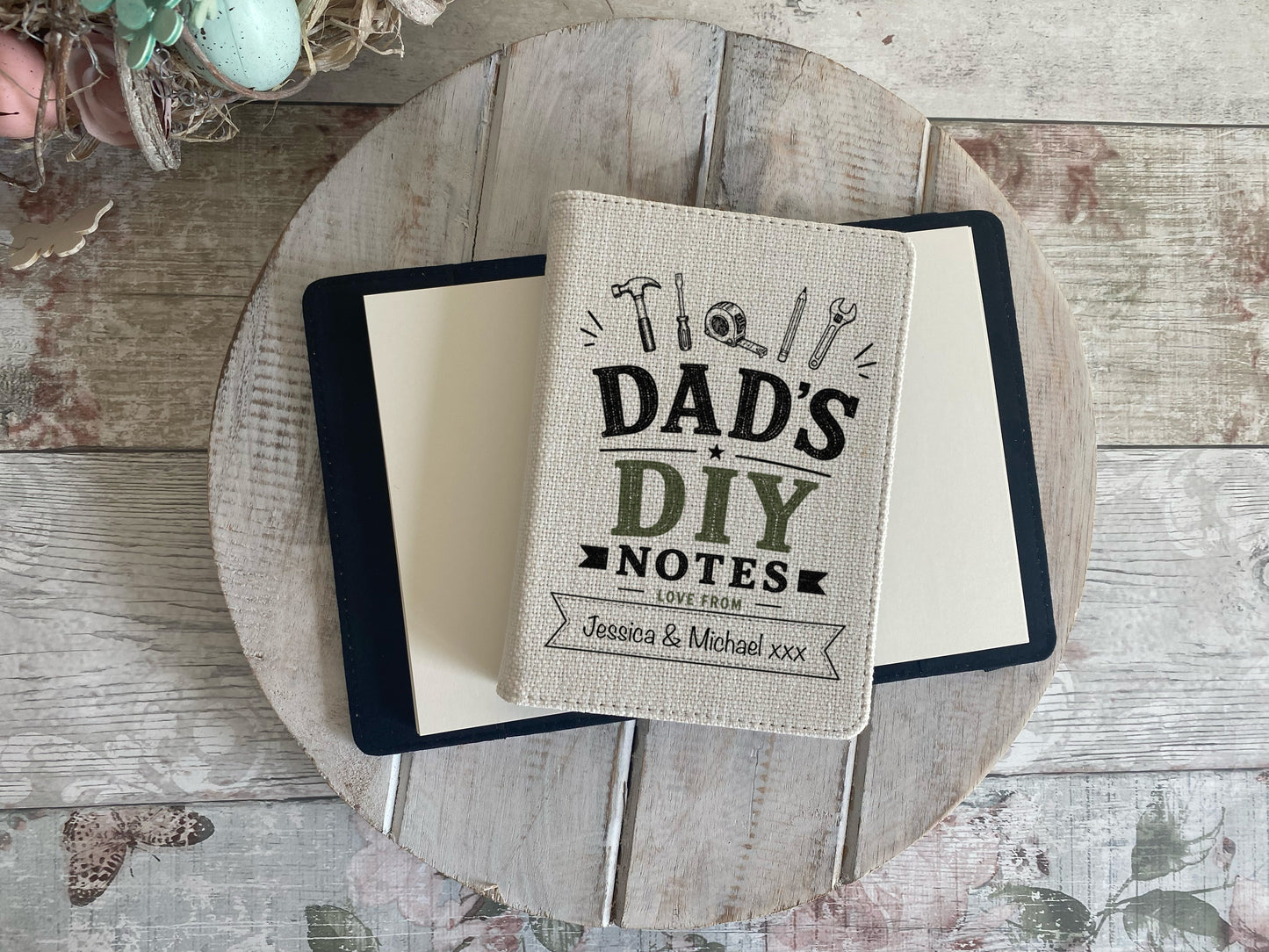 Notebook with 'Dad's DIY Notes' on a wooden surface