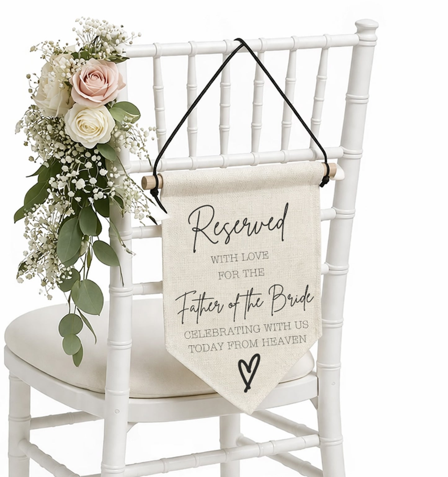White chair with floral decoration and a 'Reserved' sign for the Father of the Bride.