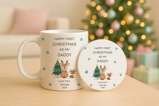 Mug and coaster set with First Christmas design and text on a table with a blurred festive background