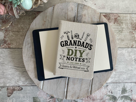 Notebook with 'Grandad's DIY Notes' cover on a wooden surface