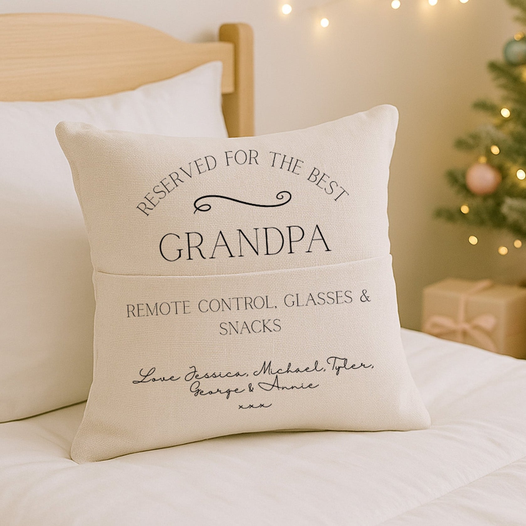 Decorative grandad pillow with personalised text on a bed with a Christmas tree in the background