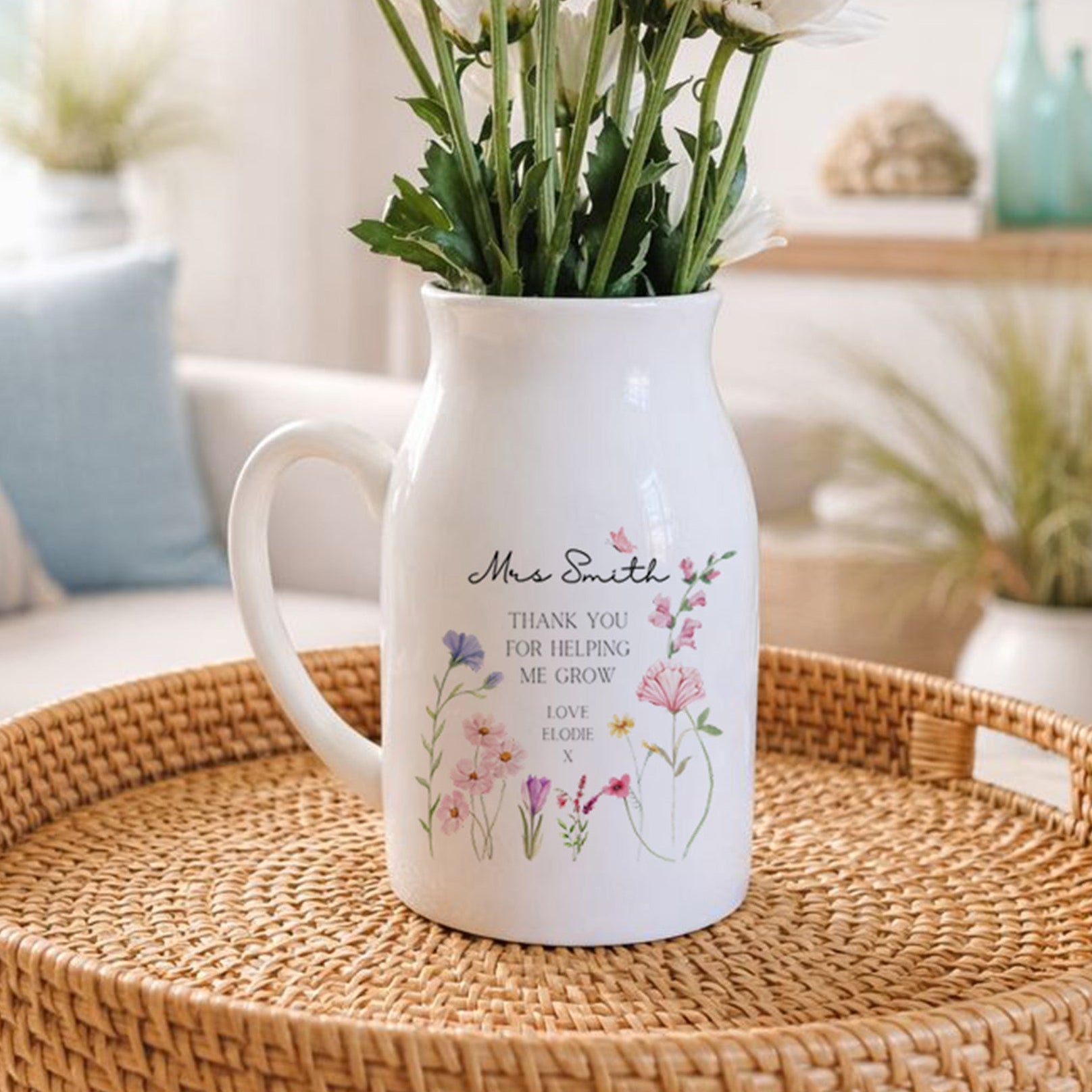 Personalised White pitcher with floral design and text on a woven surface featuring the words 'Thank You For Helping Me Grow'