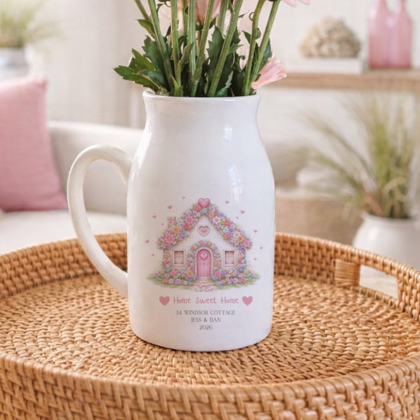 Personalised New Home flower pitcher jug with floral design on a woven tray in a cozy living room.