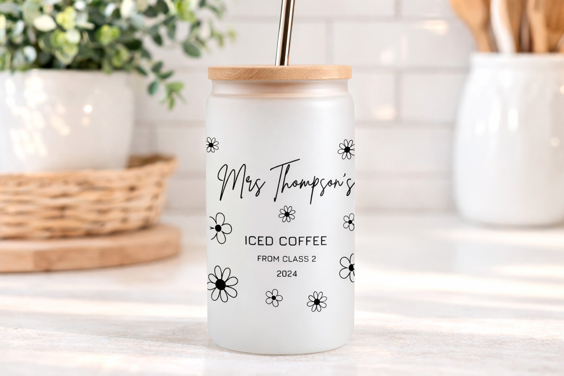 Personalized iced coffee tumbler with wooden lid on a kitchen counter