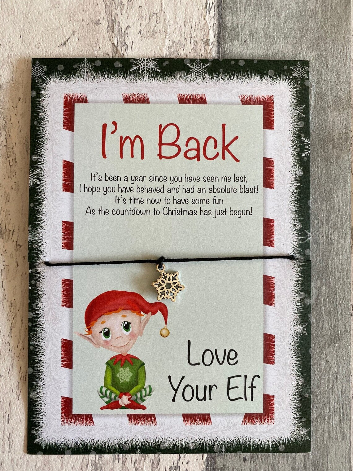 Im Back Card with an elf design and text on a wooden surface