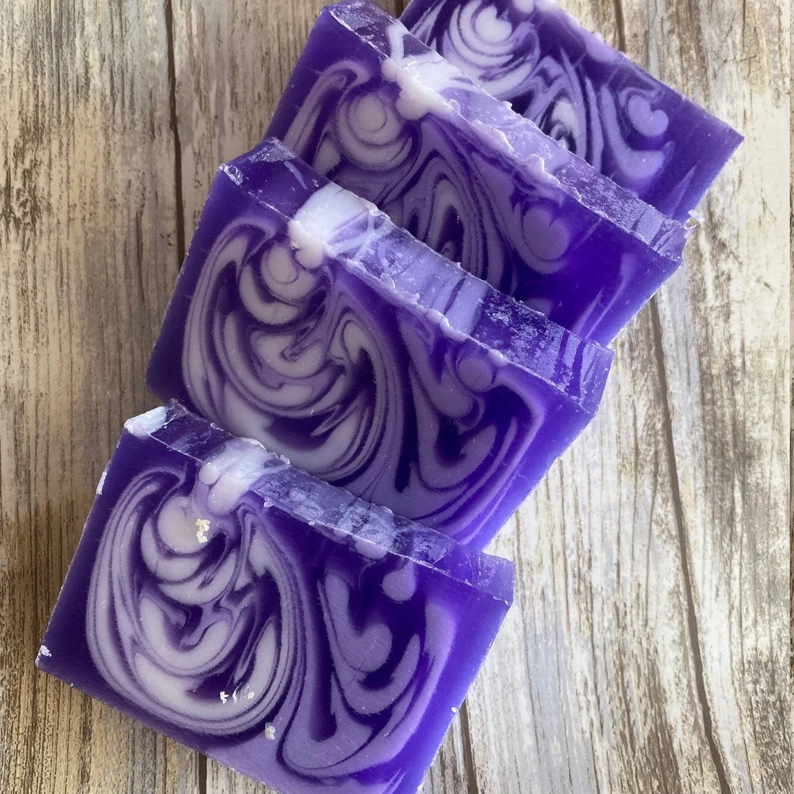 Lavender Purple and white swirled soap bars on a wooden surface