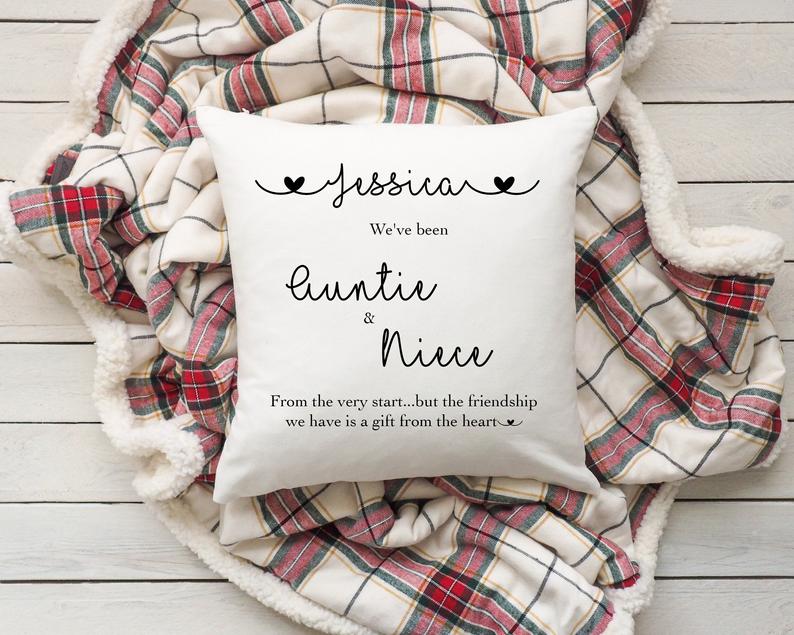 Pillow with personalised text on a plaid blanket