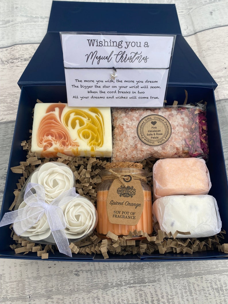 Gift set with soaps and a candle in a decorative box.
