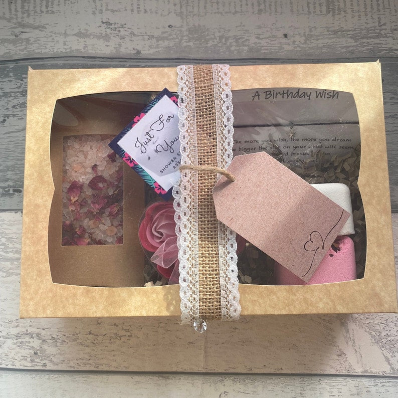 Gift box with decorative elements on a wooden surface