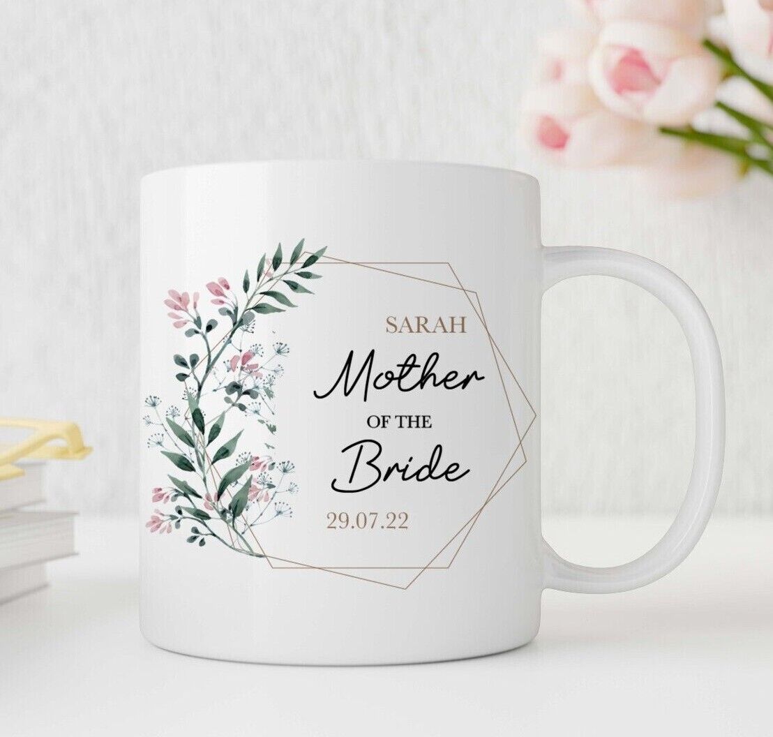 White personalised mug with floral design and text 'Sarah Mother of the Bride 29.07.22' on a light background