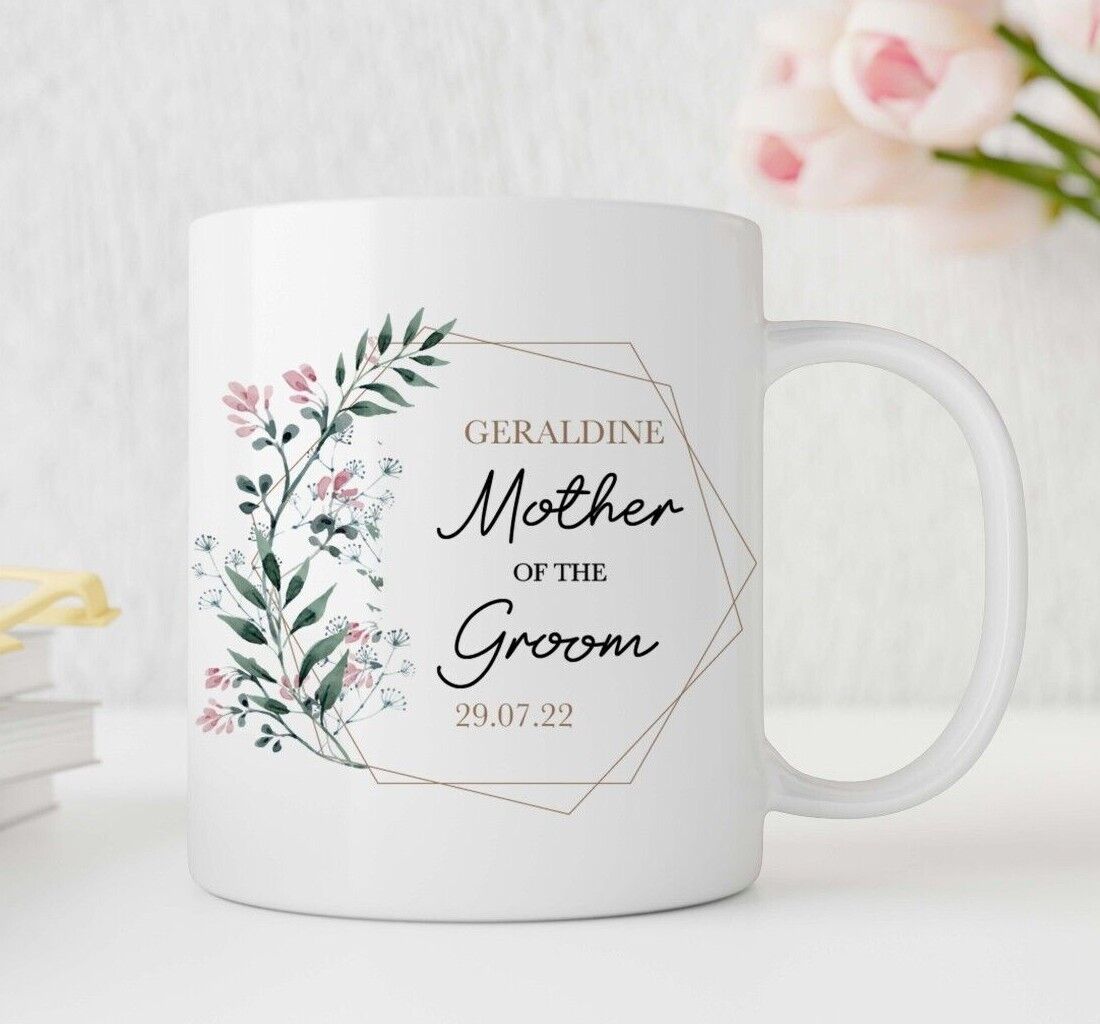White mug with floral design and text on a light background
