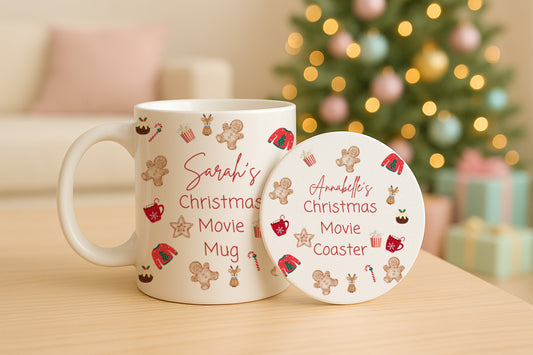 Personalised Christmas mug and coaster with gingerbread design on a table with a blurred Christmas tree in the background.