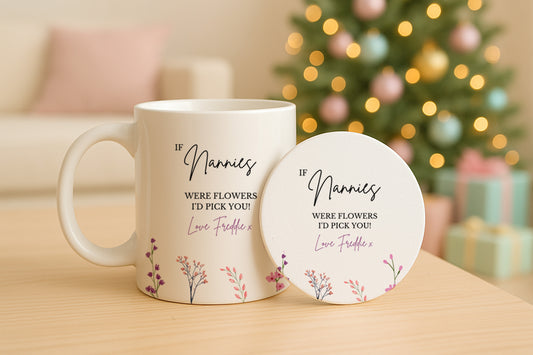 Mug and coaster set with floral design and text in front of a decorated Christmas tree.