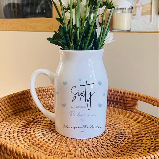 White personalised Vase with 'Sixty' text on a woven tray with flowers