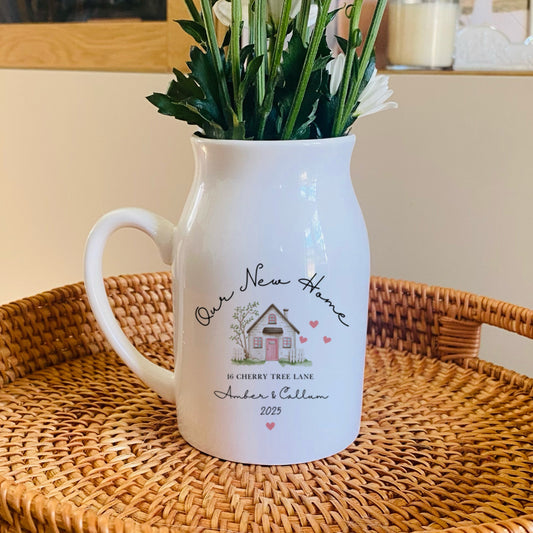 Personalised Our New Home, White pitcher with floral arrangement on a woven tray in a home setting