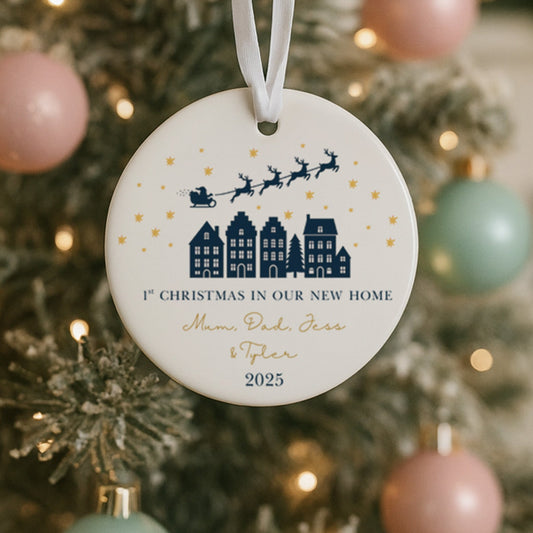 Decorative new home ornament on a Christmas tree with festive background