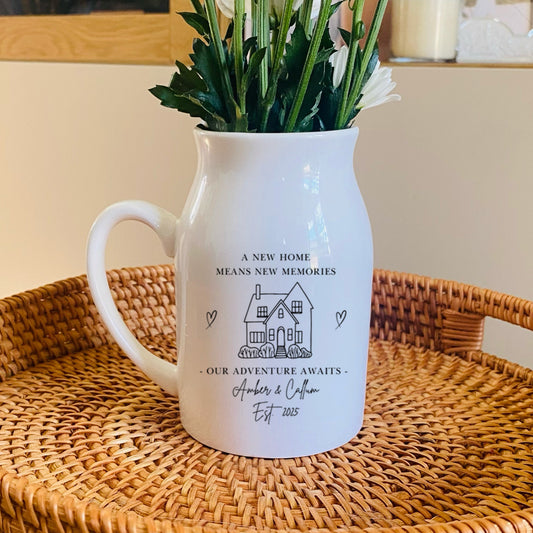 Personalised First Home Vase, a white flower jug on a woven basket and floral arrangement.
