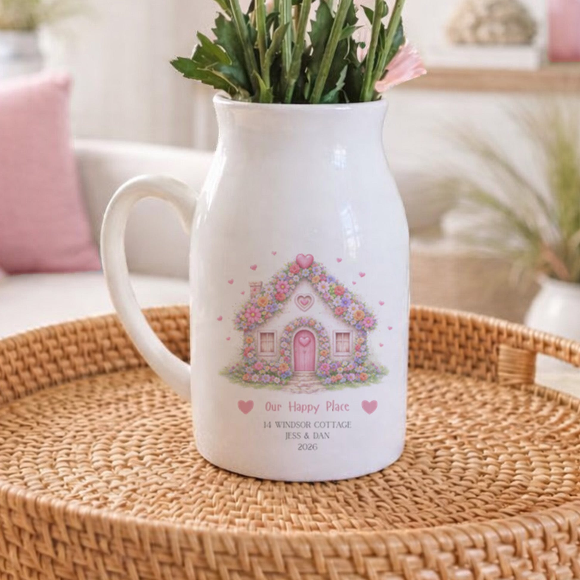 Personalised New Home flower pitcher jug with floral design on a woven tray in a cozy living room.