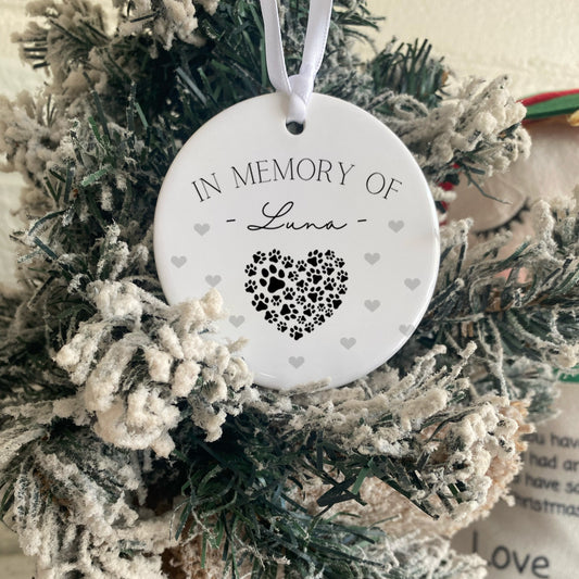 Decorative wreath with a 'In Memory of Luna' ornament on a wooden surface.