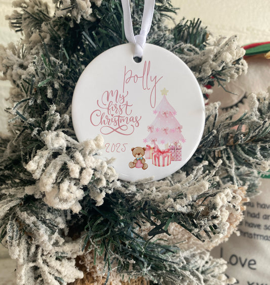 Christmas ornament with 'Polly, My First Christmas 2023' text on a decorated tree.