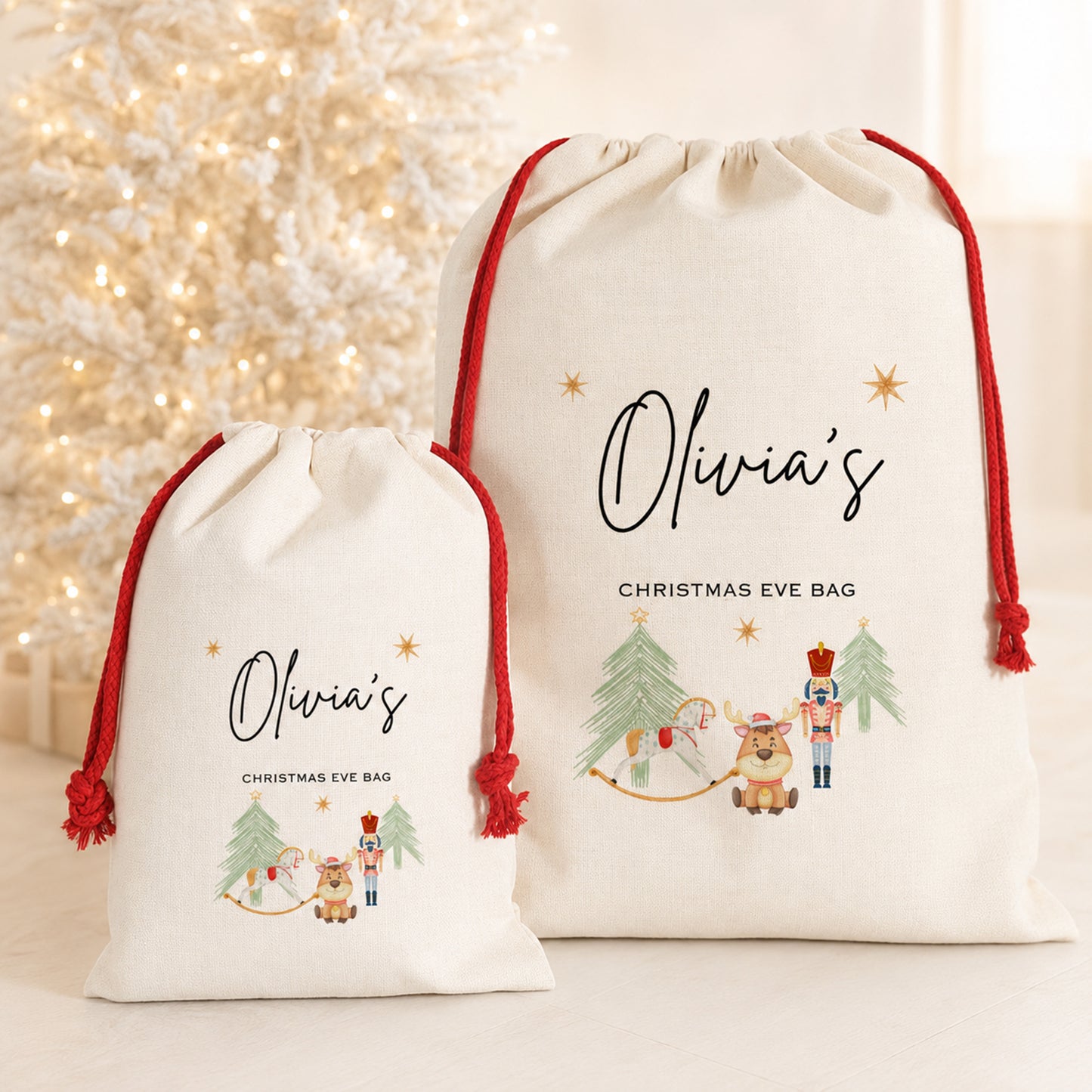 Two personalized cream Christmas Eve drawstring bags with red cords, one small and one large, printed with 'Olivia's Christmas Eve Bag' and festive illustrations, set against a warm, softly lit holiday background.