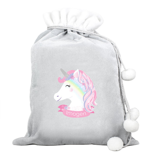 Grey Santa Sack with a Unicorn Picture and Personalised with any name. Around the top there a white finish with Grey string and white pom poms on the end. 